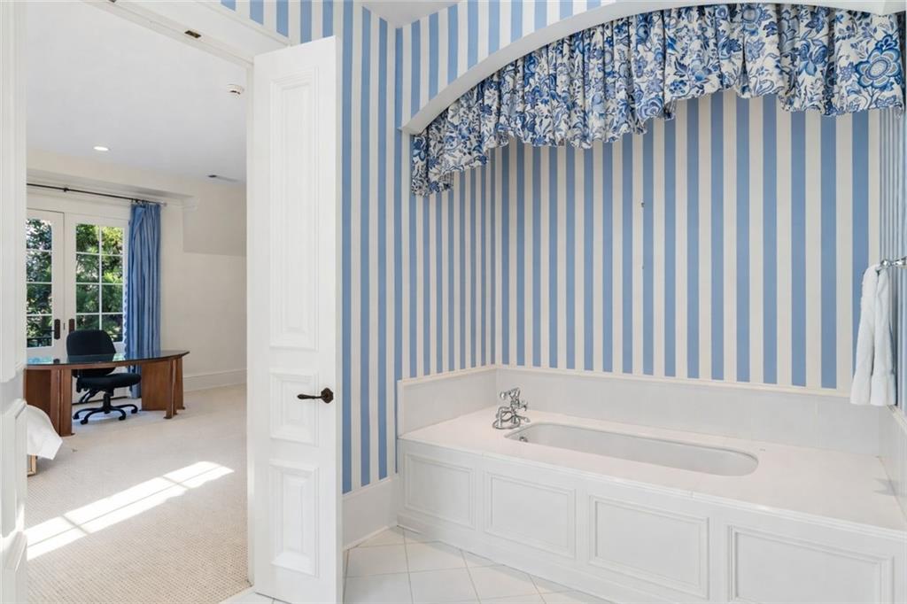 675 West Paces Ferry Road Northwest, Unit 10 Atlanta, GA 30327 - Photo 35 of 47 a bathroom with a bathtub and a window