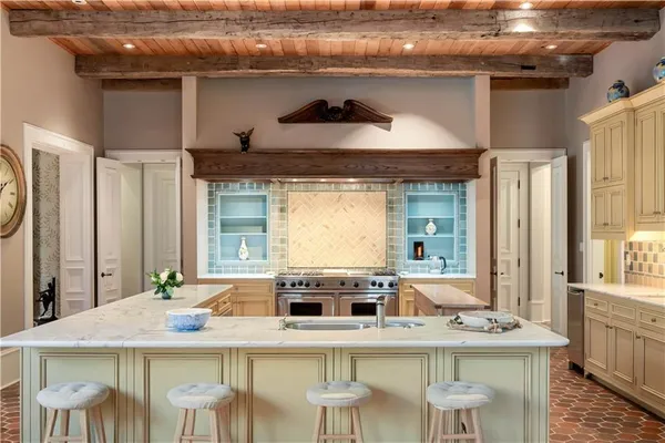 a kitchen with a stove a table and chairs