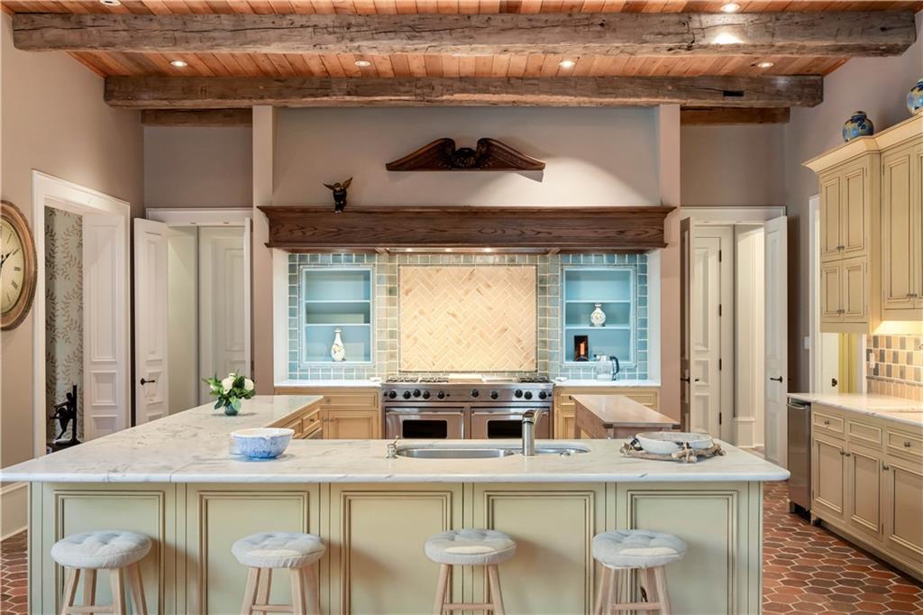 675 West Paces Ferry Road Northwest, Unit 10 Atlanta, GA 30327 - Photo 7 of 47 a kitchen with a stove a table and chairs
