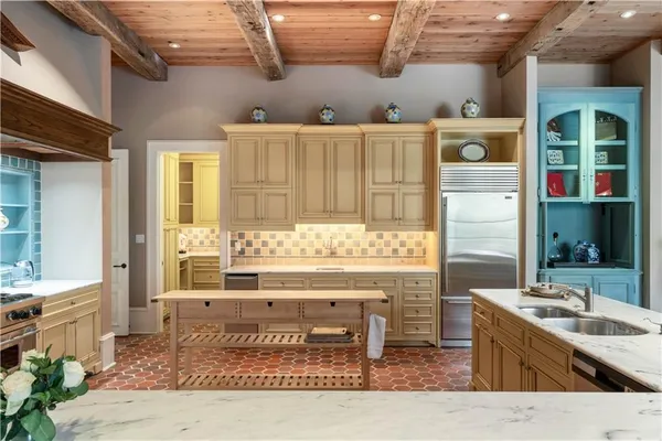 a kitchen with stainless steel appliances kitchen island granite countertop a sink and cabinets