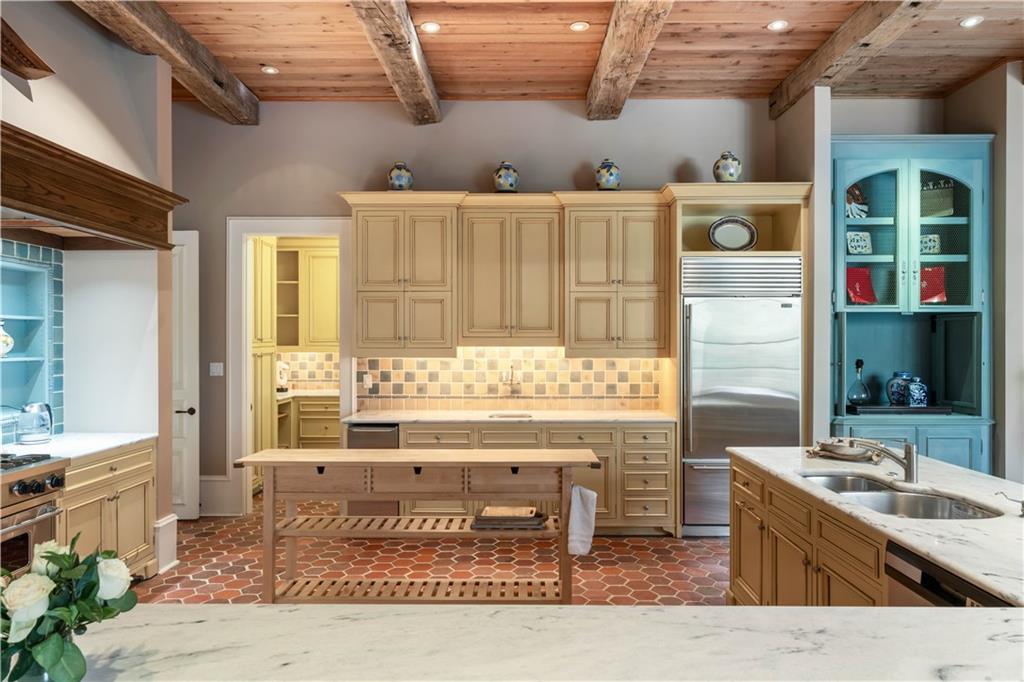 675 West Paces Ferry Road Northwest, Unit 10 Atlanta, GA 30327 - Photo 8 of 47 a kitchen with stainless steel appliances kitchen island granite countertop a sink and cabinets