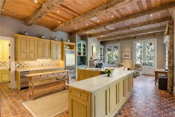 a large kitchen with kitchen island a stove a sink and a refrigerator