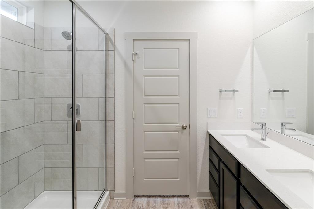 432 Agave Azul Way Leander, TX 78641 - Photo 16 of 36 A 6' walk-in shower to wash the stress of the day away.