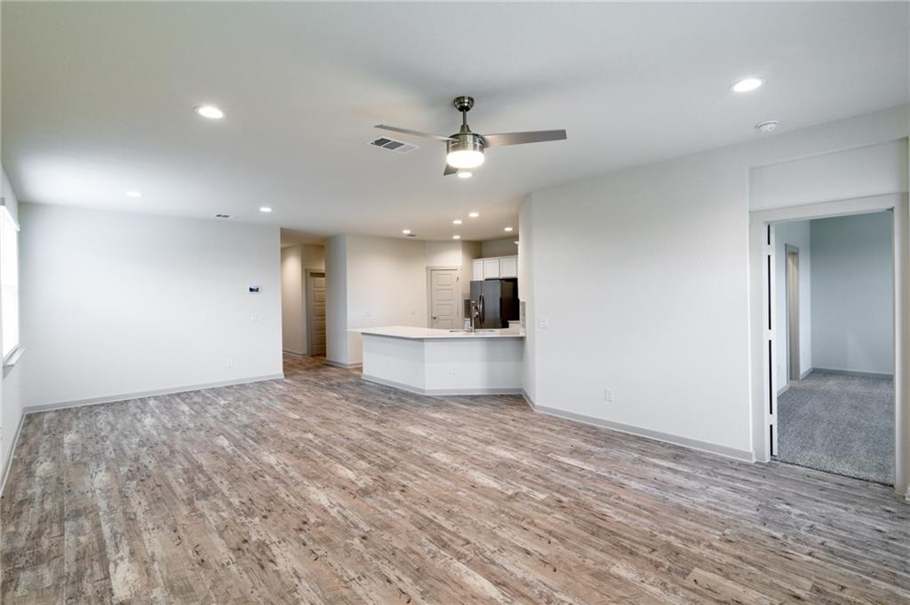 432 Agave Azul Way Leander, TX 78641 - Photo 7 of 36 Luxury Vinyl Plank flooring throughout the main areas keeps cleanup a breeze.