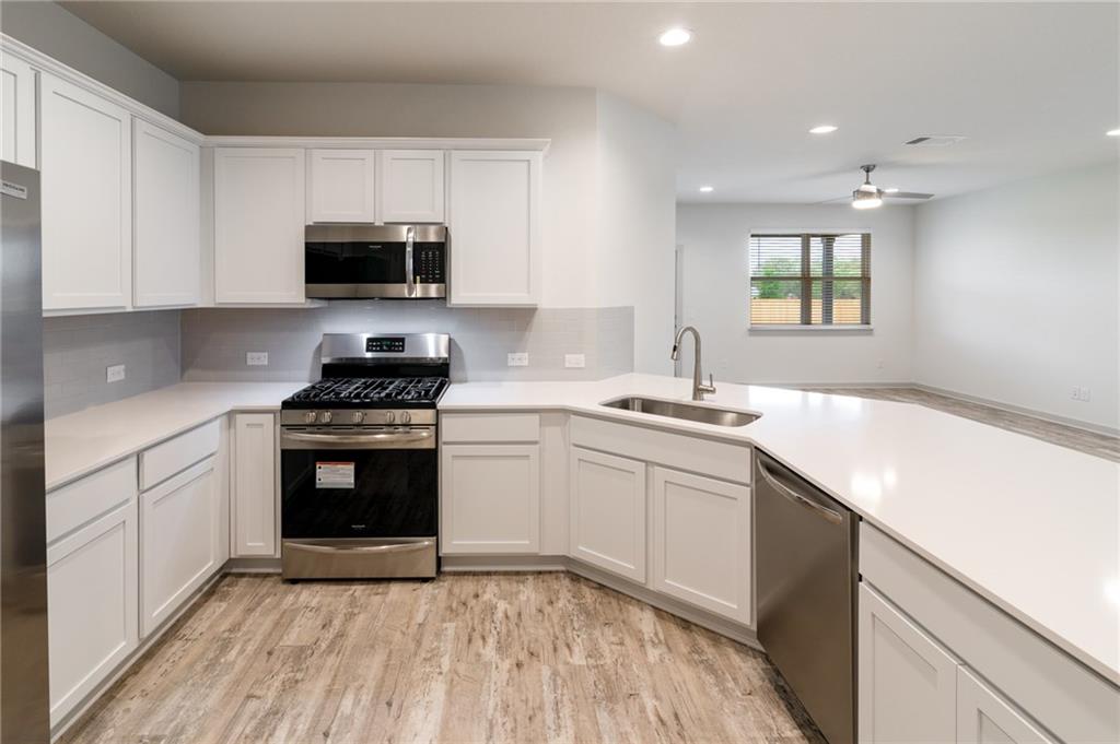 432 Agave Azul Way Leander, TX 78641 - Photo 8 of 36 Quartz counters really make this space pop.