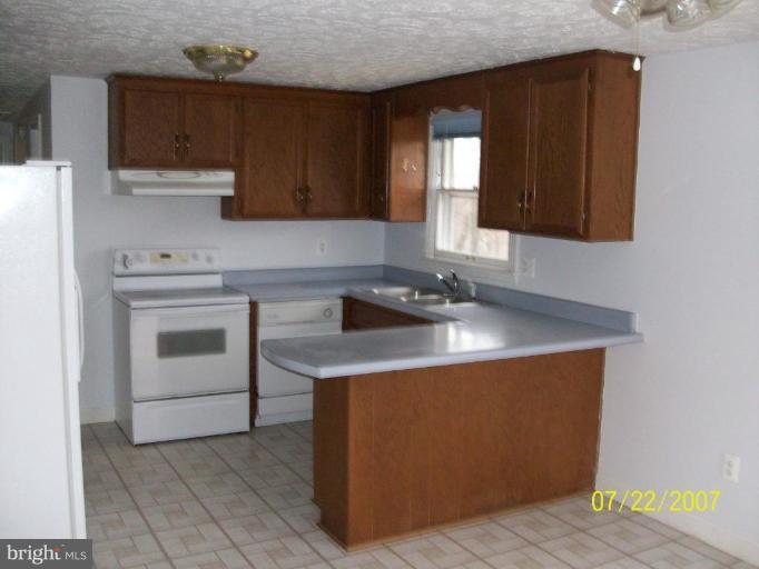 225 Granny Smith Road Linden, VA 22642 - Photo 12 of 13 a kitchen with a sink stove and cabinets