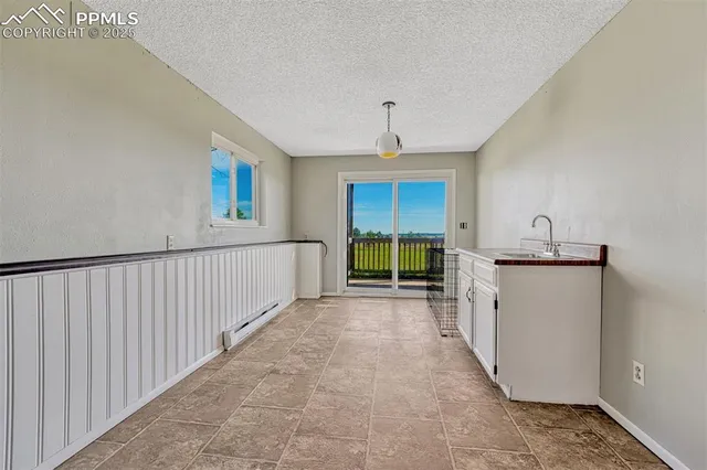 a view of a kitchen with a sink and a window