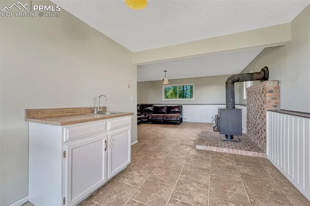 a kitchen with a refrigerator and a stove