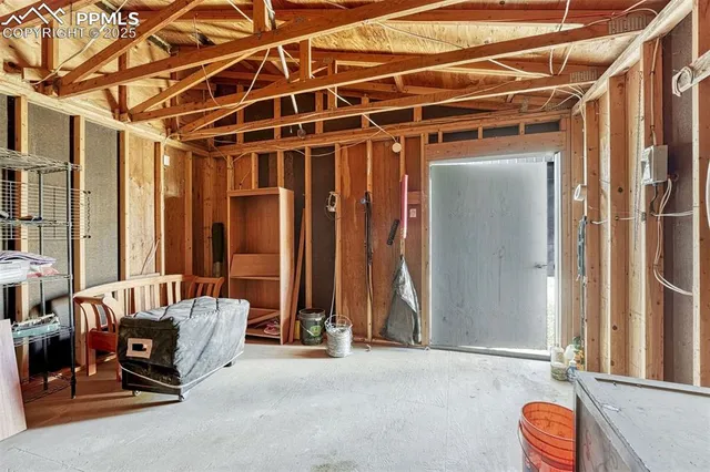 a view of a hallway with wooden floor and a bathroom