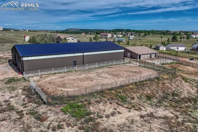 an aerial view of a house with a yard and lake view