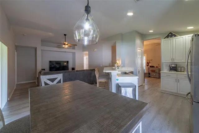 a kitchen with a refrigerator a sink dishwasher and a stove top oven with wooden floor