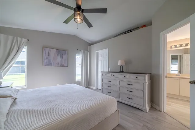 a bedroom with a large bed and a ceiling fan