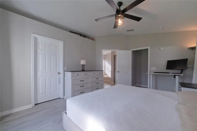 a bedroom with two beds and a large window