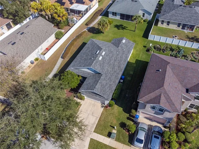 an aerial view of a house with a yard basket ball court and outdoor seating