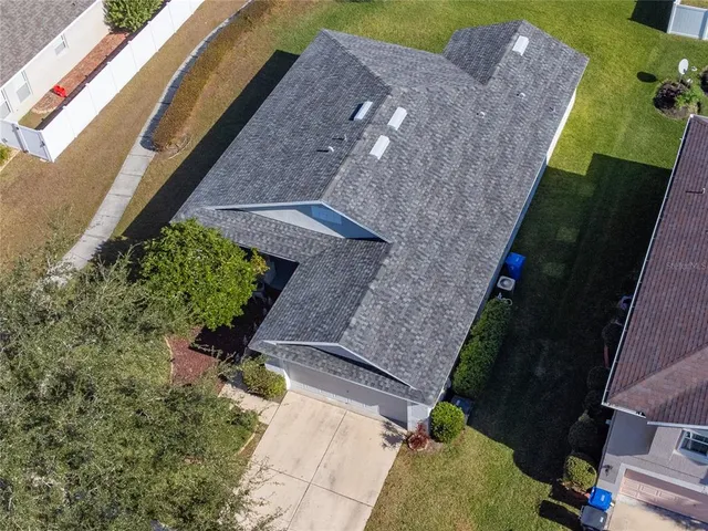 an aerial view of house with a yard