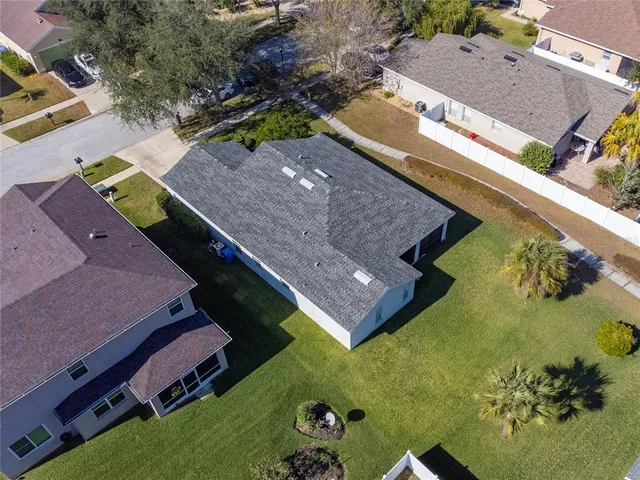 an aerial view of a house with a yard