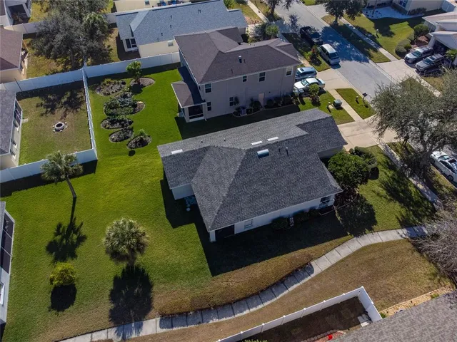 an aerial view of a house with garden space and a patio