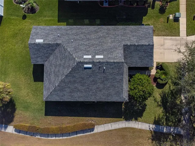 an aerial view of a house with outdoor space and a lake view