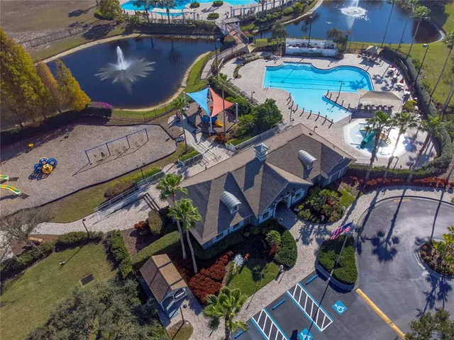a front view of a house with a yard and palm trees