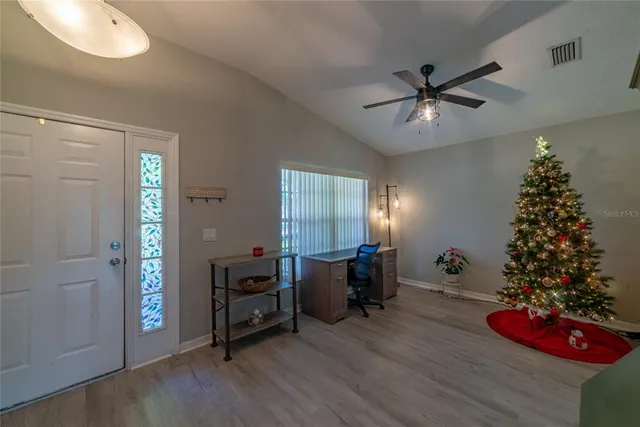 a view of a livingroom with furniture window and wooden floor