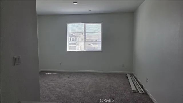 a view of a hallway with wooden fence