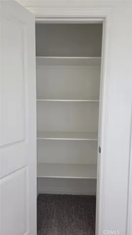 a white toilet sitting in a bathroom next to a sink