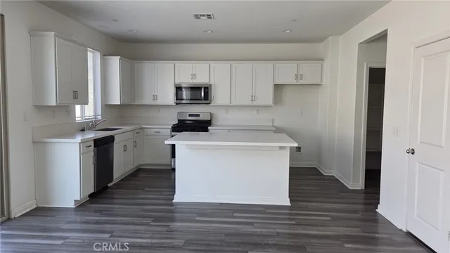 a kitchen with a white stove top oven and white refrigerator