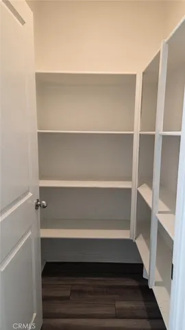 a view of closet with wooden floor and stairs