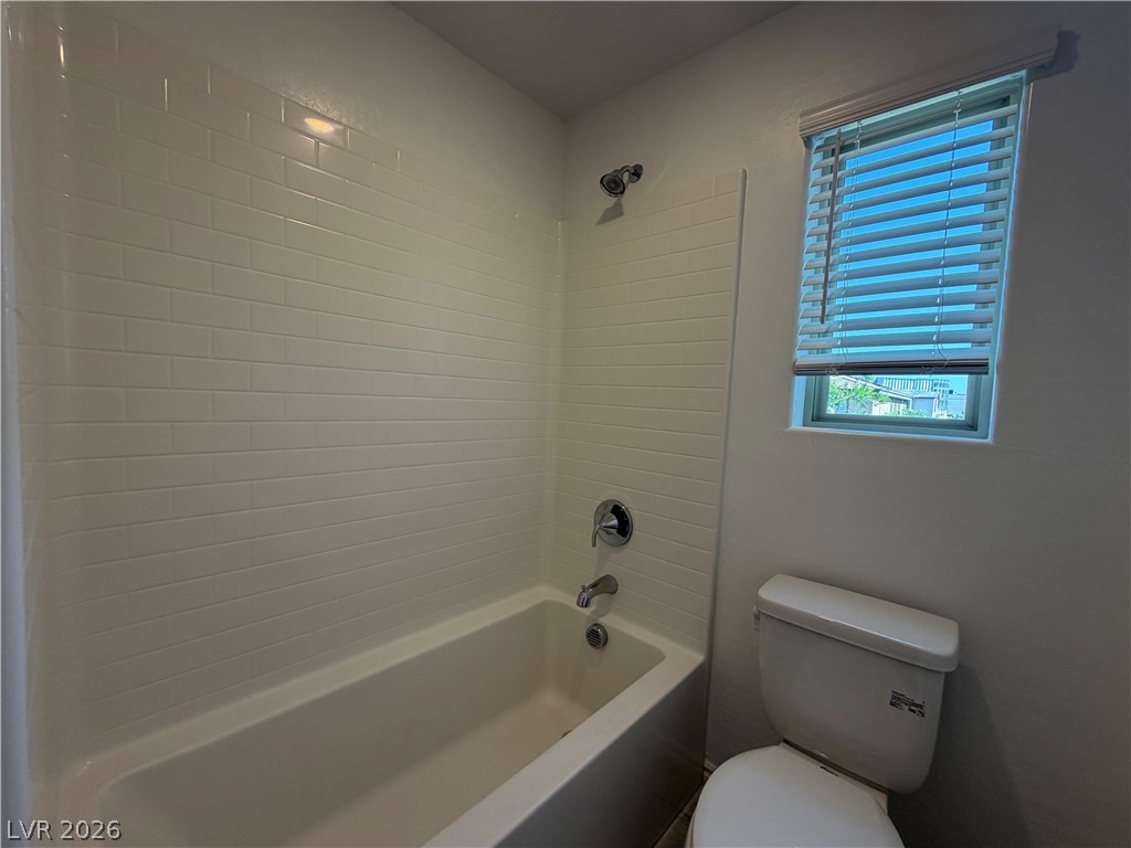 3228 Azalea Ridge Court Henderson, NV 89052 - Photo 15 of 28 A well-maintained tub-shower combination offers a serene and clean bathing experience.