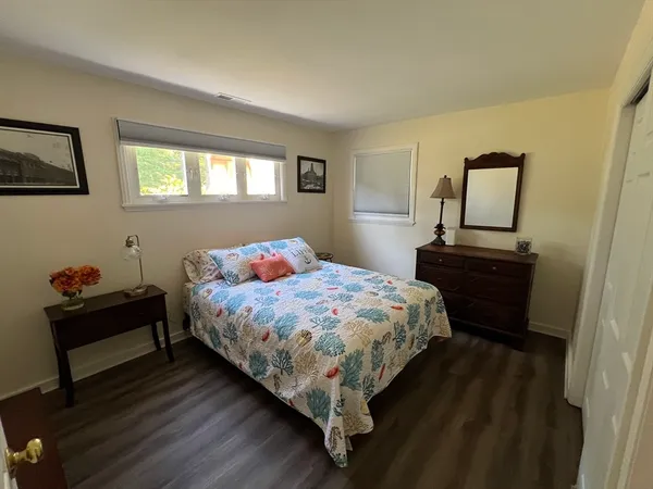 a bedroom with a bed table and window