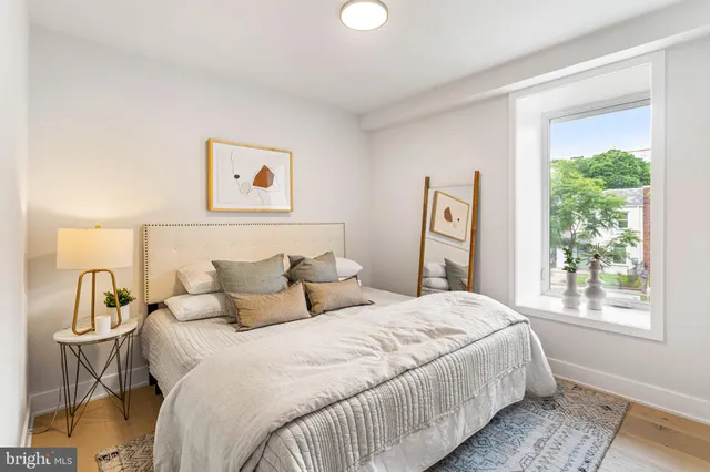 a bedroom with a bed and a large window