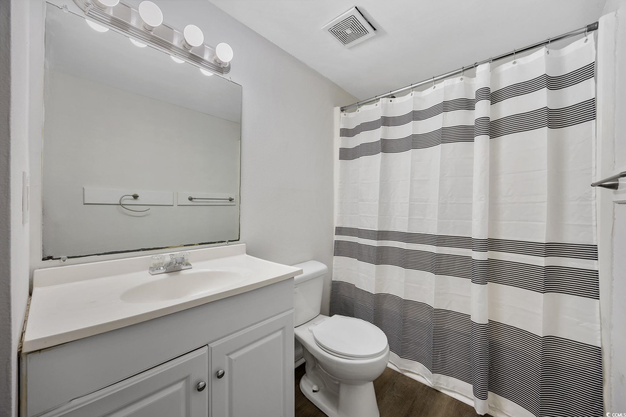 3555 Highway 544, Unit 8H Conway, SC 29526 - Photo 12 of 22 Bathroom featuring vanity, wood finished floors, and curtained shower