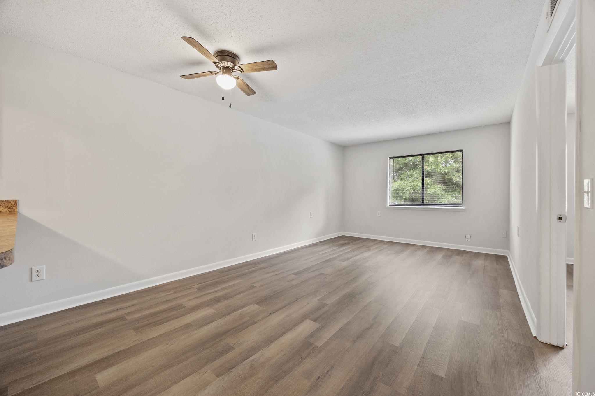 3555 Highway 544, Unit 8H Conway, SC 29526 - Photo 16 of 22 Spare room with ceiling fan, dark wood-style flooring, and a textured ceiling