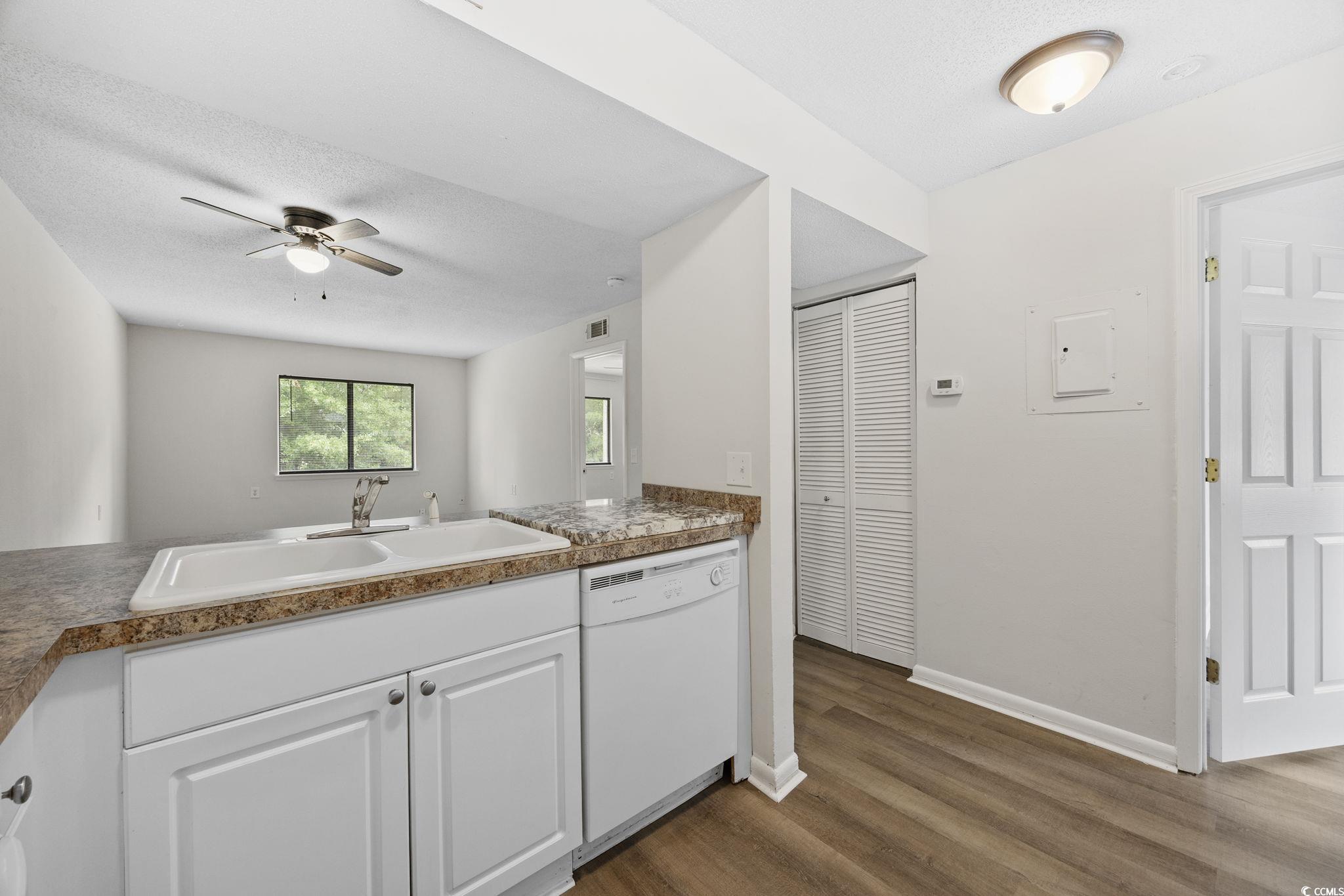 3555 Highway 544, Unit 8H Conway, SC 29526 - Photo 8 of 22 Kitchen with white dishwasher, dark wood-type flooring, ceiling fan, white cabinets, and electric panel