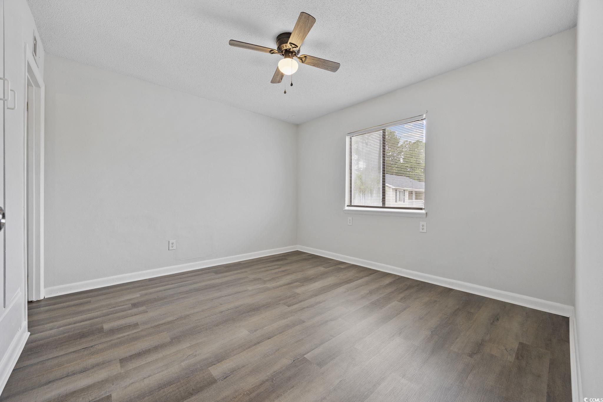 3555 Highway 544, Unit 8H Conway, SC 29526 - Photo 10 of 22 Unfurnished room with ceiling fan, wood finished floors, and a textured ceiling