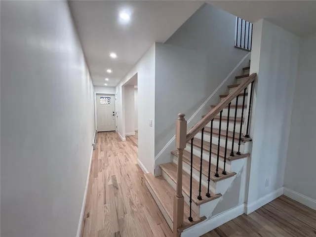 a view of an entryway with wooden floor