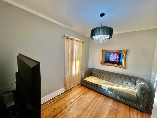a bathroom with a tub and a chandelier