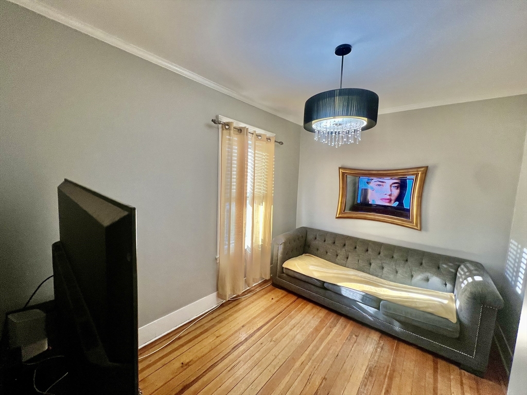 41 Pearl Street, Unit 2 Everett, MA 02149 - Photo 11 of 26 a bathroom with a tub and a chandelier