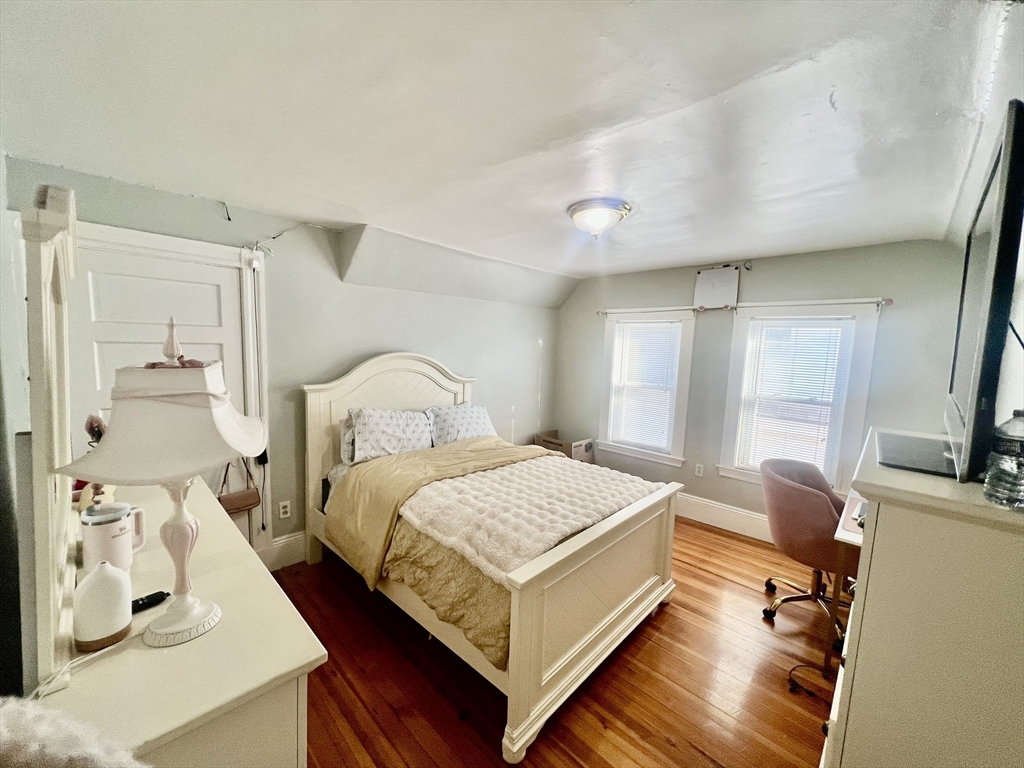 41 Pearl Street, Unit 2 Everett, MA 02149 - Photo 14 of 26 a bedroom with a bed and flat screen tv