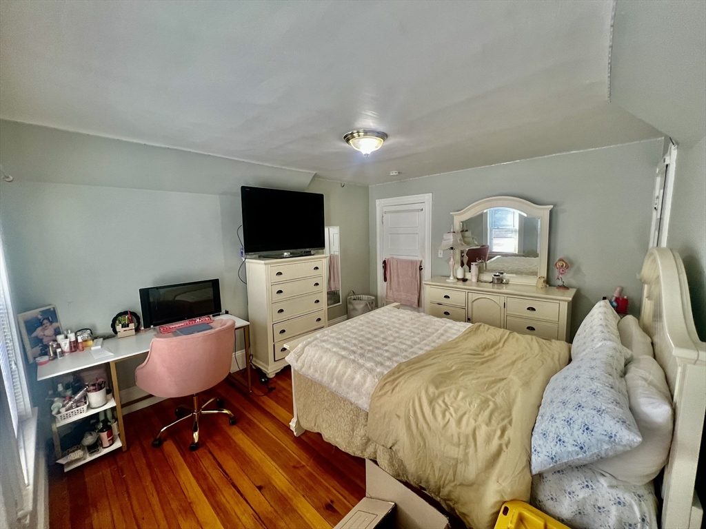 41 Pearl Street, Unit 2 Everett, MA 02149 - Photo 15 of 26 a spacious bedroom with a bed and a flat screen tv