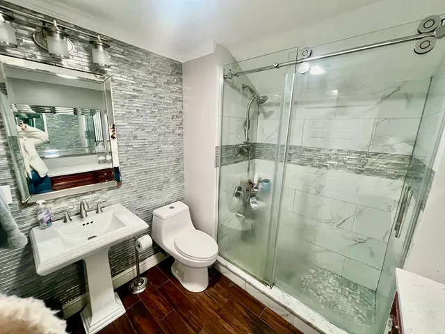 a bathroom with a sink toilet and shower