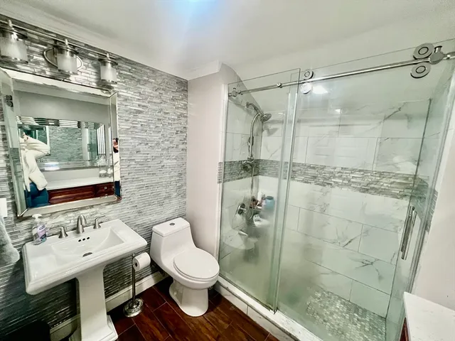 a bathroom with a sink toilet and shower