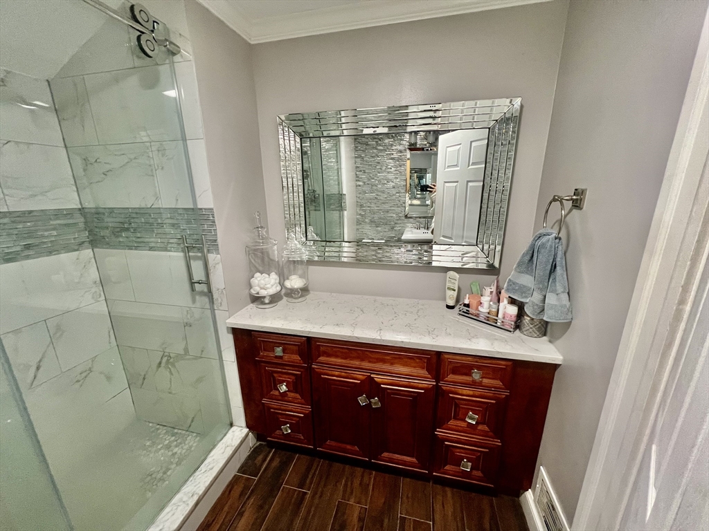 41 Pearl Street, Unit 2 Everett, MA 02149 - Photo 18 of 26 a bathroom with a sink a mirror and next to a window