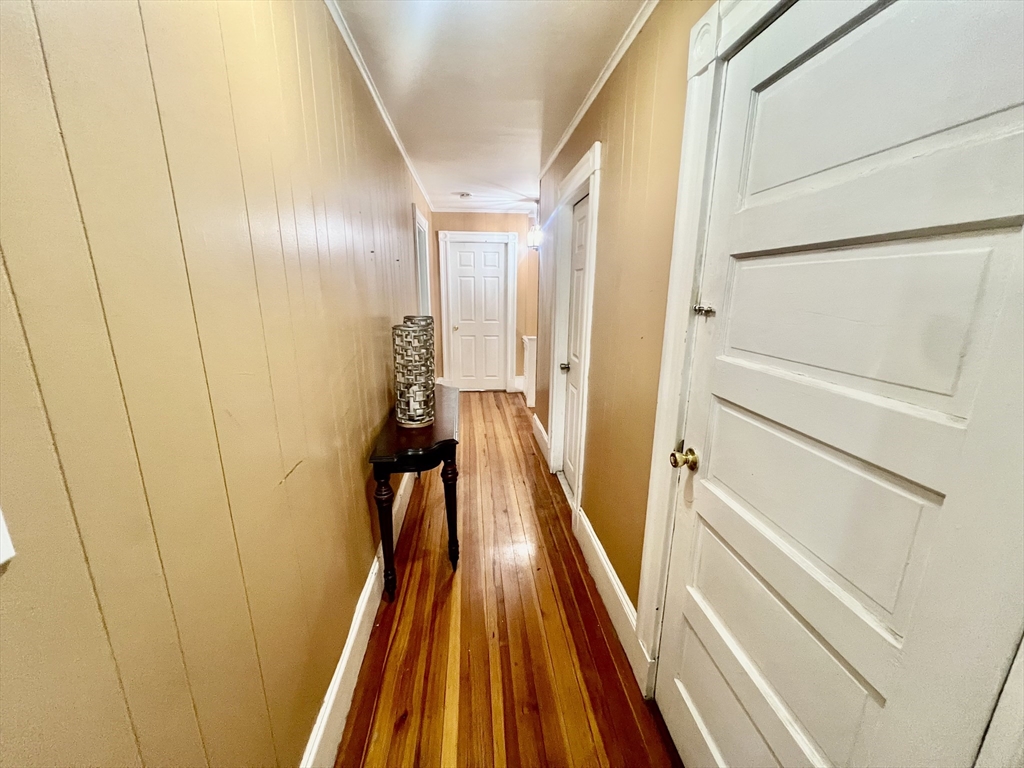 41 Pearl Street, Unit 2 Everett, MA 02149 - Photo 19 of 26 a view of a hallway with wooden floor and staircase