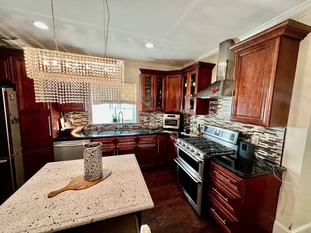 41 Pearl Street, Unit 2 Everett, MA 02149 - Photo 2 of 26 a kitchen with stainless steel appliances granite countertop a stove and a sink