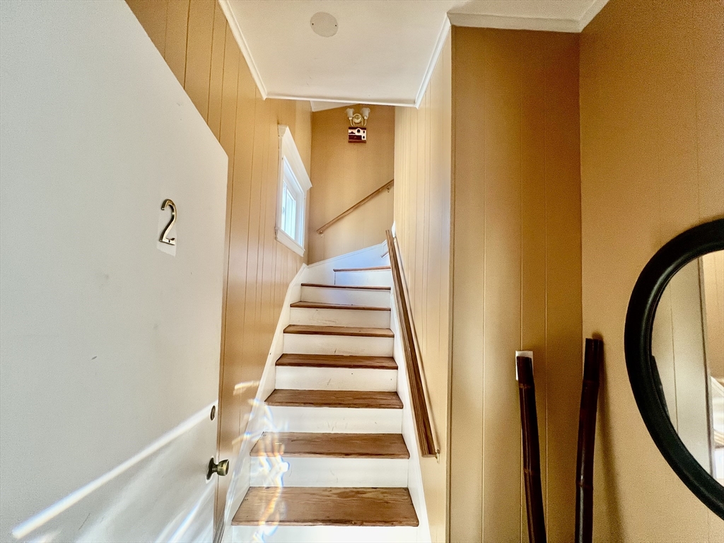 41 Pearl Street, Unit 2 Everett, MA 02149 - Photo 23 of 26 a view of a staircase with wooden floor and a potted plant