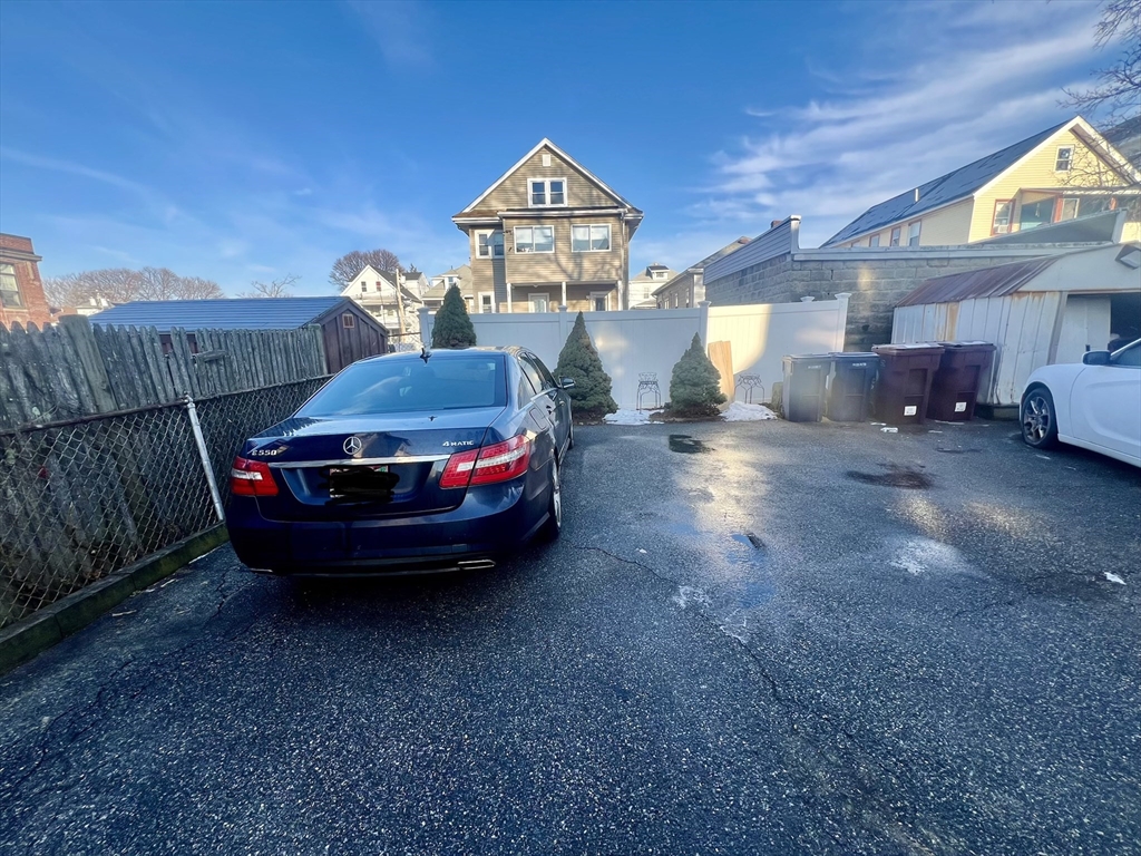 41 Pearl Street, Unit 2 Everett, MA 02149 - Photo 26 of 26 a car parked in a room next to a house