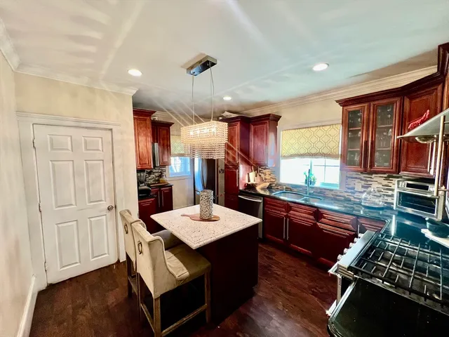 a kitchen with a sink appliances and cabinets