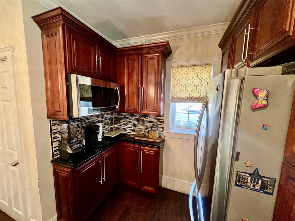 41 Pearl Street, Unit 2 Everett, MA 02149 - Photo 4 of 26 a kitchen with stainless steel appliances granite countertop a refrigerator and a stove