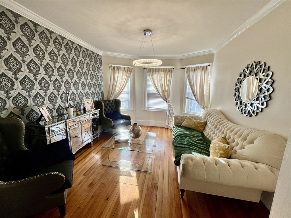 41 Pearl Street, Unit 2 Everett, MA 02149 - Photo 6 of 26 a living room with furniture and a wooden floor